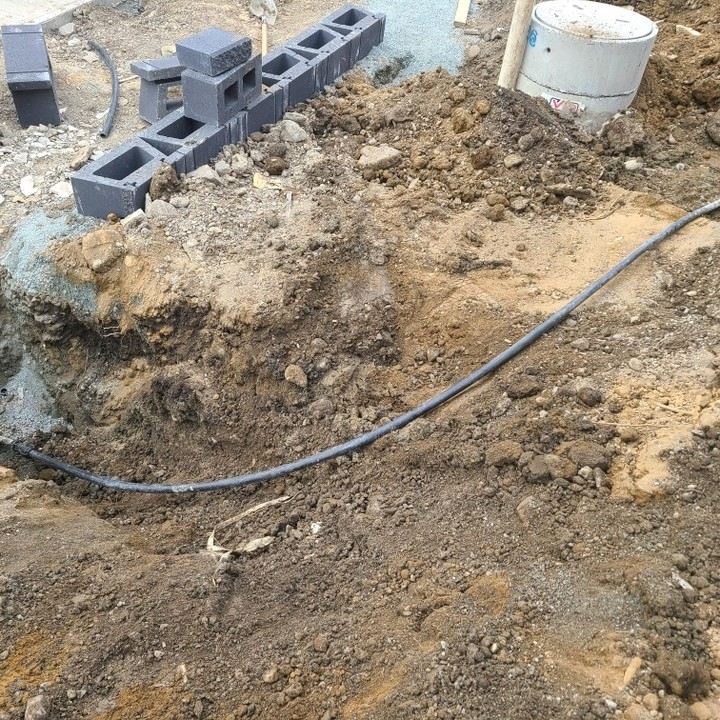 Water line install with catch basin and block wall base