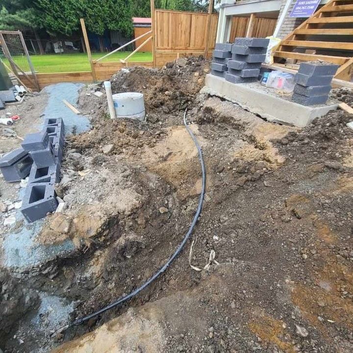 Water line install beside retaining blocks and concrete steps
