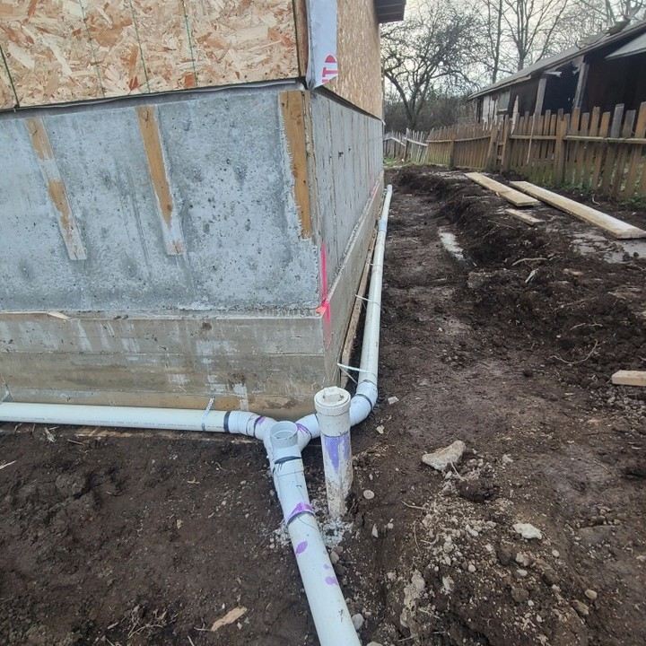 Perimeter drain pipe installed around a foundation