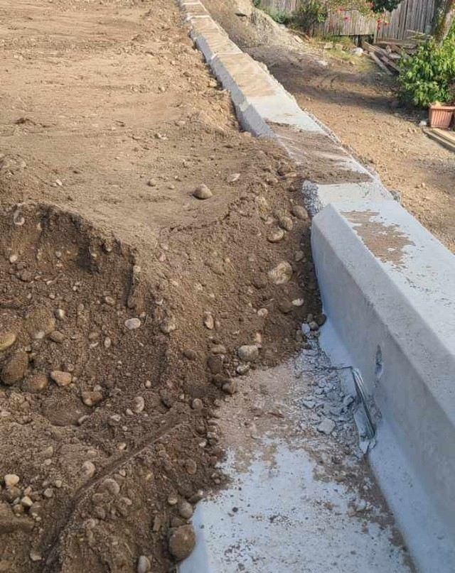 Concrete lock block wall install along a graded yard