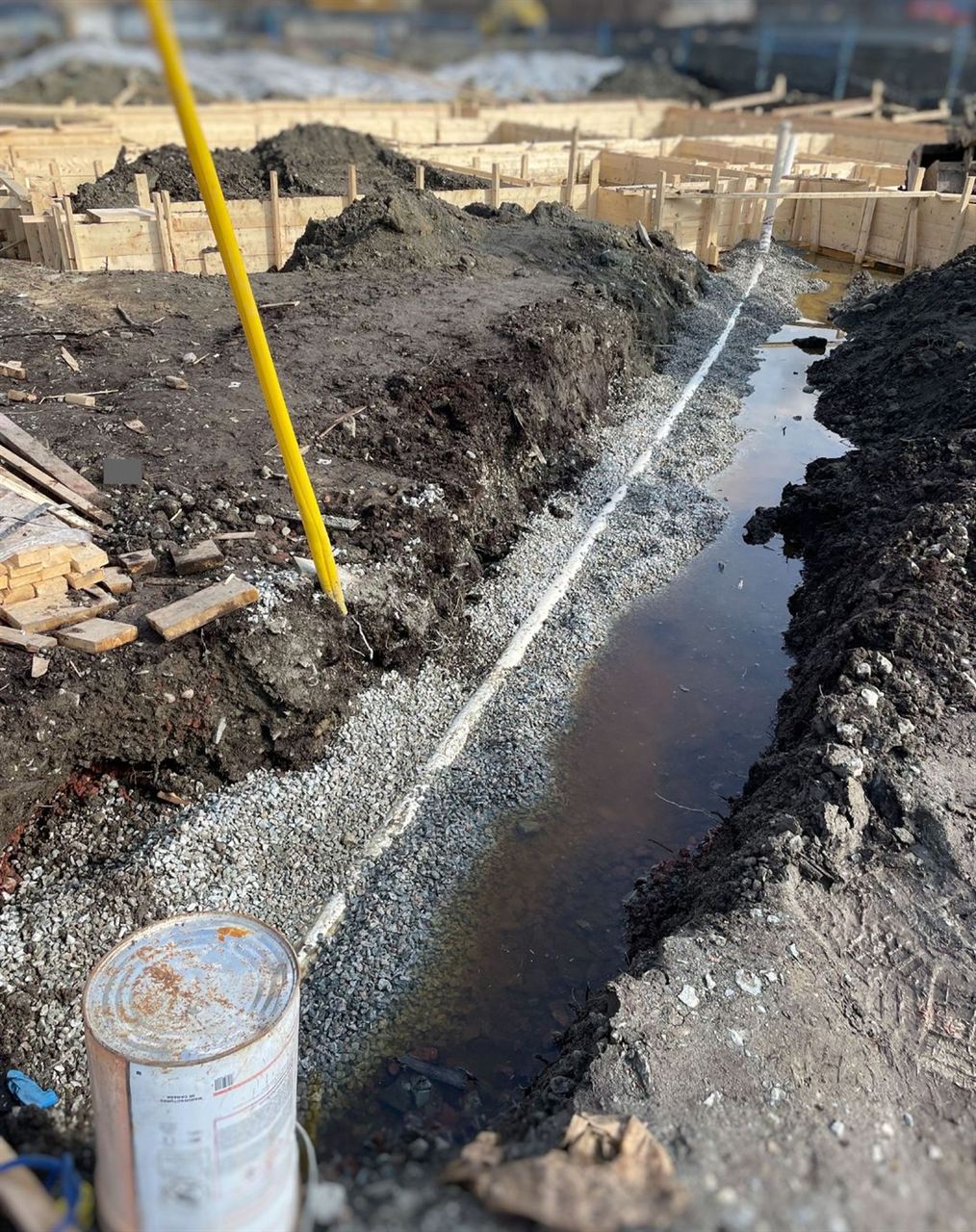 Concrete catch basin set in gravel for a sanitary line