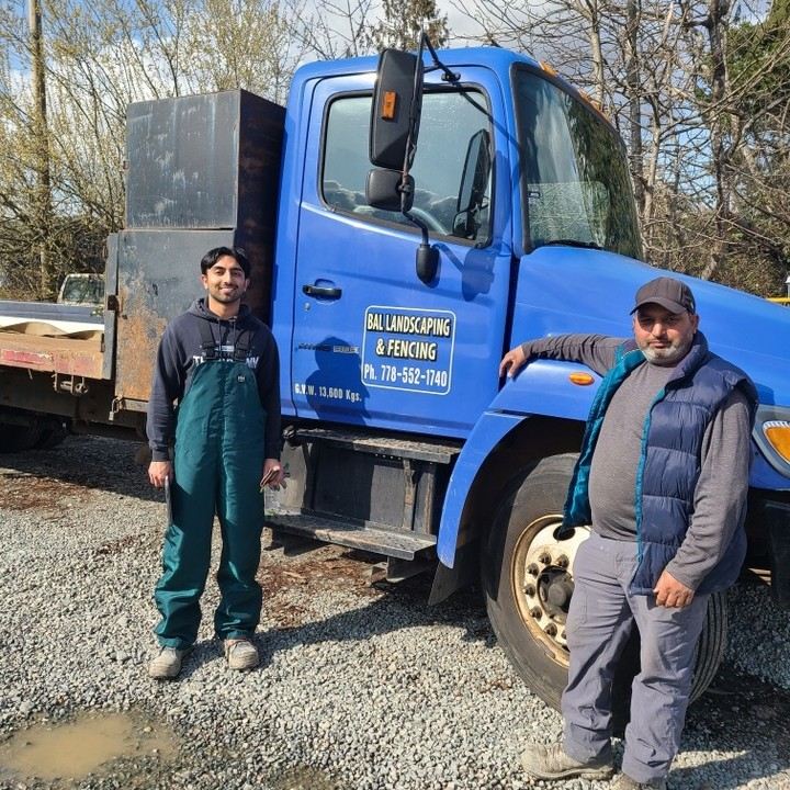 The Bal Landscaping & Fencing crew standing beside their branded blue truck
